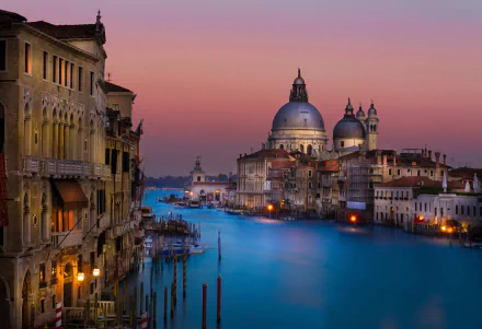 Evening view of Venice's Grand Canal at night, showcasing historic buildings and a serene waterway under a colorful sky, captured in HD for a PC desktop background.