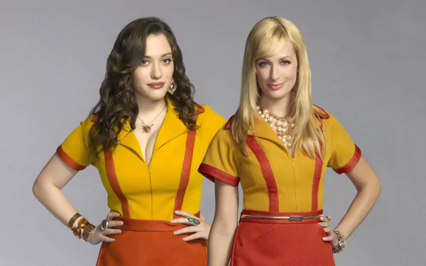 Max Black and Beth Behrs from the TV show 2 Broke Girls pose together in matching yellow and red outfits, featured as a vibrant HD desktop wallpaper.