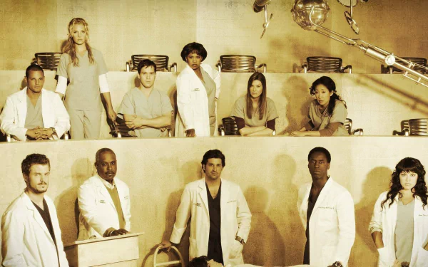 HD desktop wallpaper featuring the cast of the TV show Grey's Anatomy gathered in a clinical setting with medical equipment and seating, portraying the characters in their professional roles.