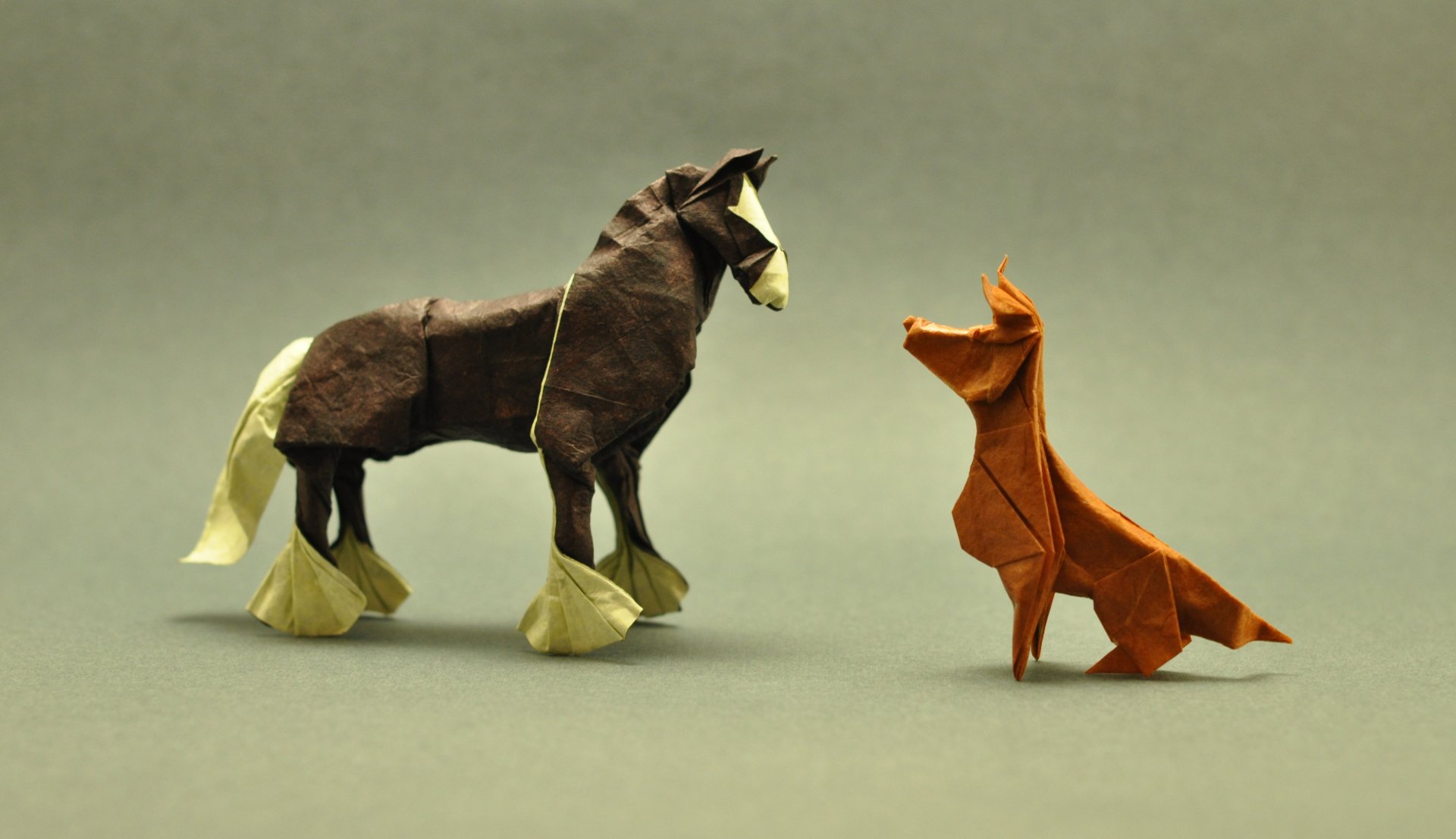 A detailed origami horse and dog stand against a muted background, showcasing intricate craftsmanship in this vibrant 4K Ultra HD wallpaper.