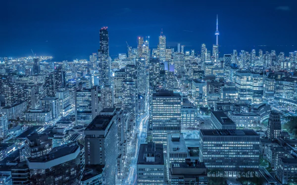 A stunning night view of Toronto, showcasing its vibrant skyline filled with skyscrapers and city lights. This HD image captures the essence of Canada's urban landscape.