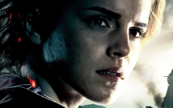 Close-up of Hermione Granger, portrayed by Emma Watson, from Harry Potter and the Deathly Hallows: Part 2, showcasing her determined expression in a dramatic HD movie wallpaper.