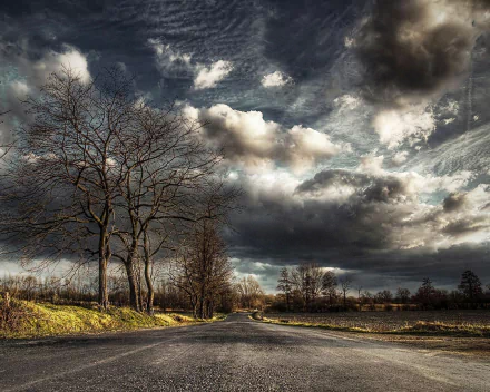  storm clouds hanging oner rural road