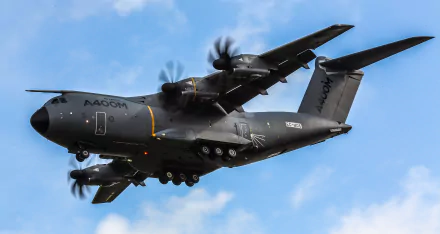 Airbus A400M military transport aircraft flying against a blue sky, captured in 4K Ultra HD quality for a desktop wallpaper background.