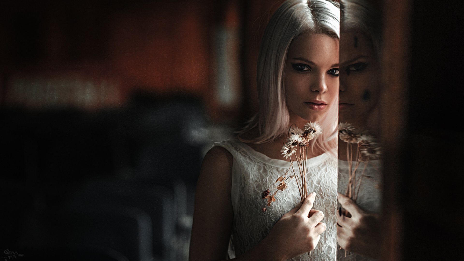 A woman with white hair and a flower poses while reflecting on a glass surface, creating a serene and artistic HD desktop wallpaper background.