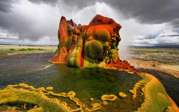 Fly Geyser's vivid mineral mounds and steaming pools under a dramatic sky — nature scene, 2K Quad HD PC desktop wallpaper/background.