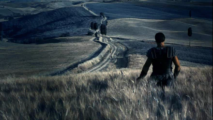 A gladiator stands in a serene landscape, gazing at a winding path that stretches across rolling hills. HD desktop wallpaper and background from the movie Gladiator.