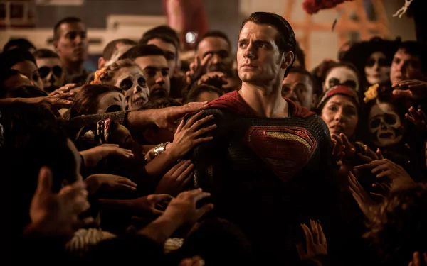HD wallpaper featuring Henry Cavill as Superman in a scene from Batman V Superman: Dawn Of Justice, surrounded by a crowd reaching out towards him.
