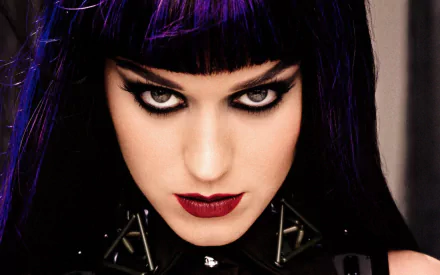 A striking HD image of American singer Katy Perry, showcasing bold lipstick and dramatic eye makeup, capturing her intense expression in a music-themed aesthetic.