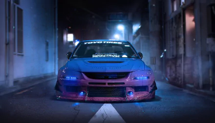 Front view of a tuned Mitsubishi Lancer Evolution, tagged as JDM and tuning, on a dimly lit street at night. The car features custom bodywork and blue accent lighting. HD desktop wallpaper background.