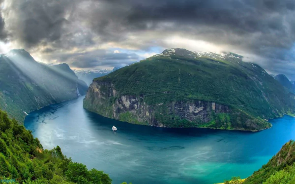 HD PC desktop wallpaper featuring a stunning Norwegian fjord landscape with mountains, a river, lake, sunshine breaking through clouds, and lush greenery.