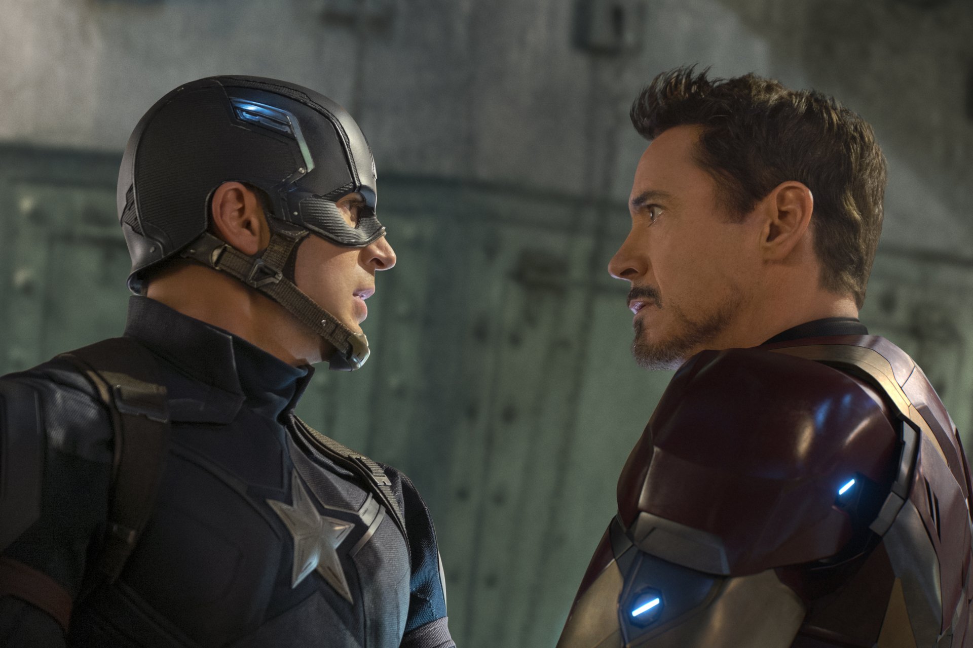 HD wallpaper featuring Captain America (Chris Evans) and Iron Man (Robert Downey Jr.) staring intensely at each other from the movie Captain America: Civil War.