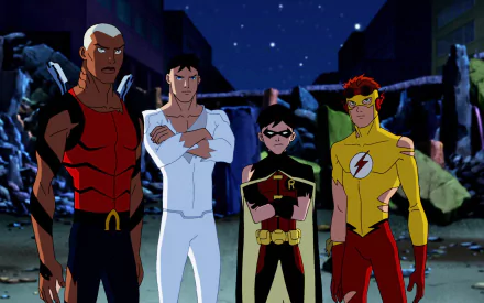 Young Justice characters Conner Kent, Kaldur'ahm, Dick Grayson, and Wally West stand together in a dramatic scene from the TV show, set against a backdrop of ruins.