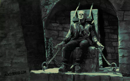 HD desktop wallpaper depicting the dark, iconic Frankenstein monster from the 1931 movie, chained and seated against a stone wall background.