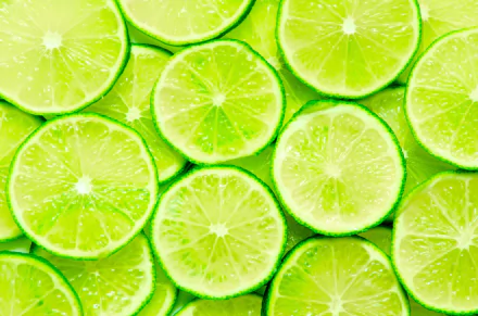 A vibrant 4K Ultra HD desktop wallpaper featuring fresh, juicy lime slices with bright green hues and detailed texture, highlighting the fruit's natural freshness.