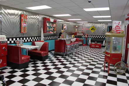 Retro-themed room with red chairs, tables, checkered floor, and vintage decor, captured in stunning 4K Ultra HD quality for a PC desktop wallpaper and background.