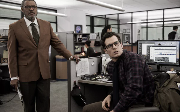 Superman and Clark Kent, portrayed by Henry Cavill, interact in the Daily Planet office, with Perry White, played by Laurence Fishburne, in this scene from *Batman V Superman: Dawn Of Justice*.