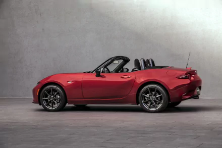 HD desktop wallpaper featuring a red Mazda MX-5 convertible sports car against a neutral gray background.