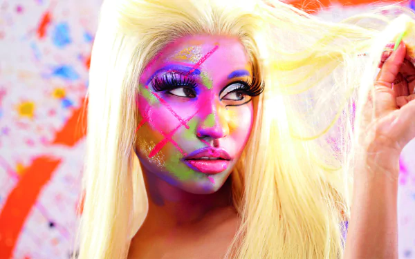 A vibrant HD wallpaper featuring Nicki Minaj with bold, colorful face paint against a splashy background, exuding confidence and artistry in music.