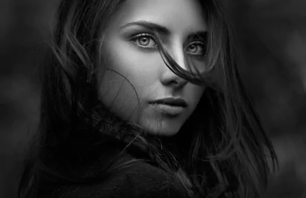 Black and white portrait of brunette model Nadya Ryzhevolosaya with intense eyes, captured in a close-up face shot for an HD desktop wallpaper.