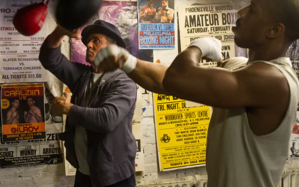 HD PC desktop wallpaper featuring Sylvester Stallone as Rocky Balboa training Michael B. Jordan as Adonis Creed in the movie Creed.