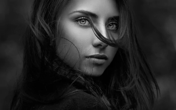 Black and white portrait of brunette model Nadya Ryzhevolosaya with intense eyes, captured in a close-up face shot for an HD desktop wallpaper.