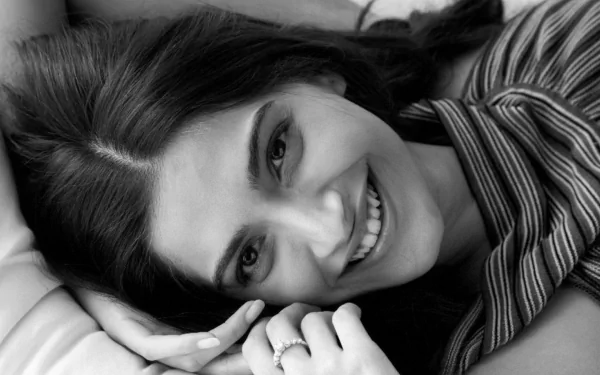 Black & white close-up of Indian actress Sonam Kapoor smiling. The HD desktop wallpaper and background highlights her joyful expression.