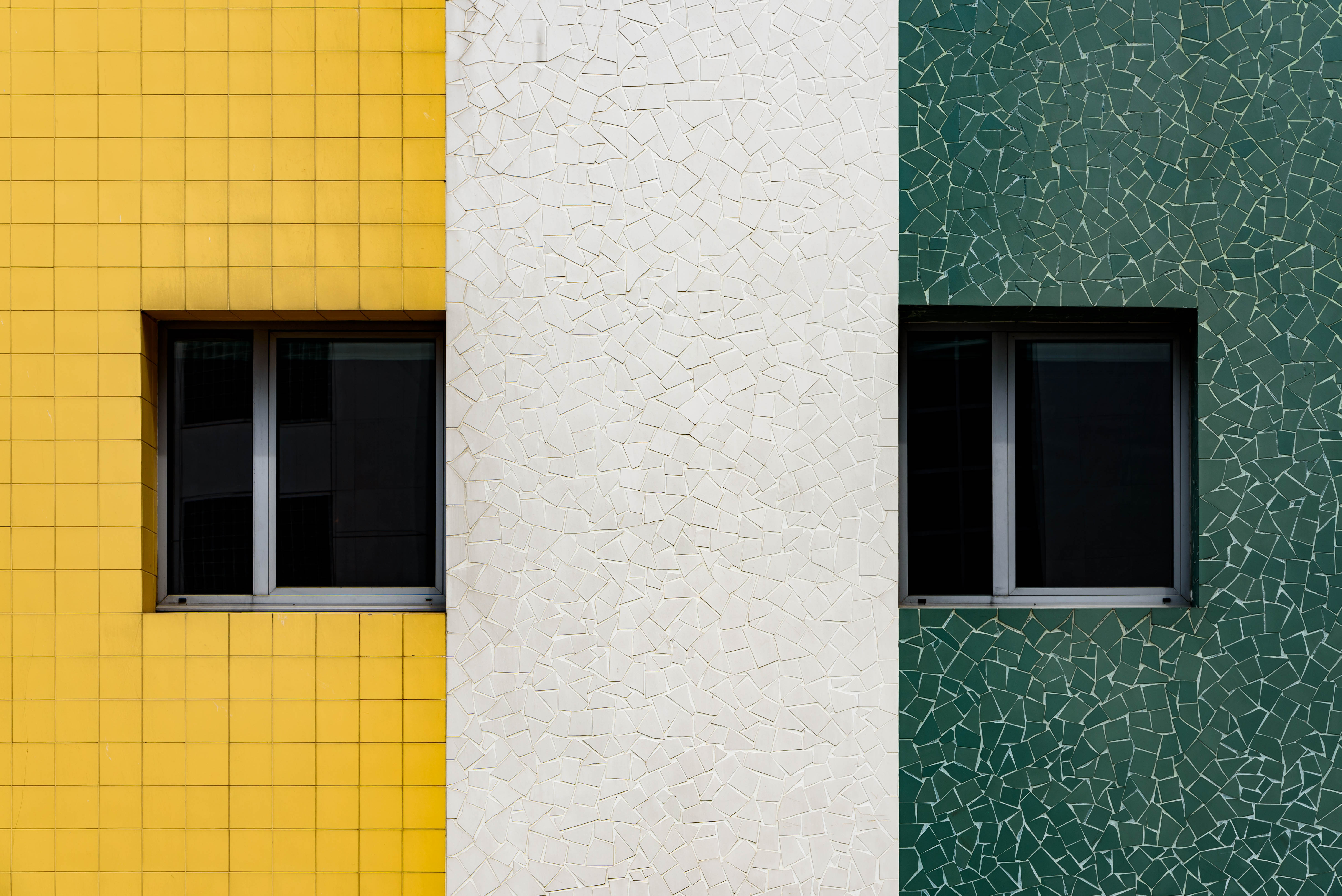 Yellow, white and green tiled wall in france by Joe deSousa