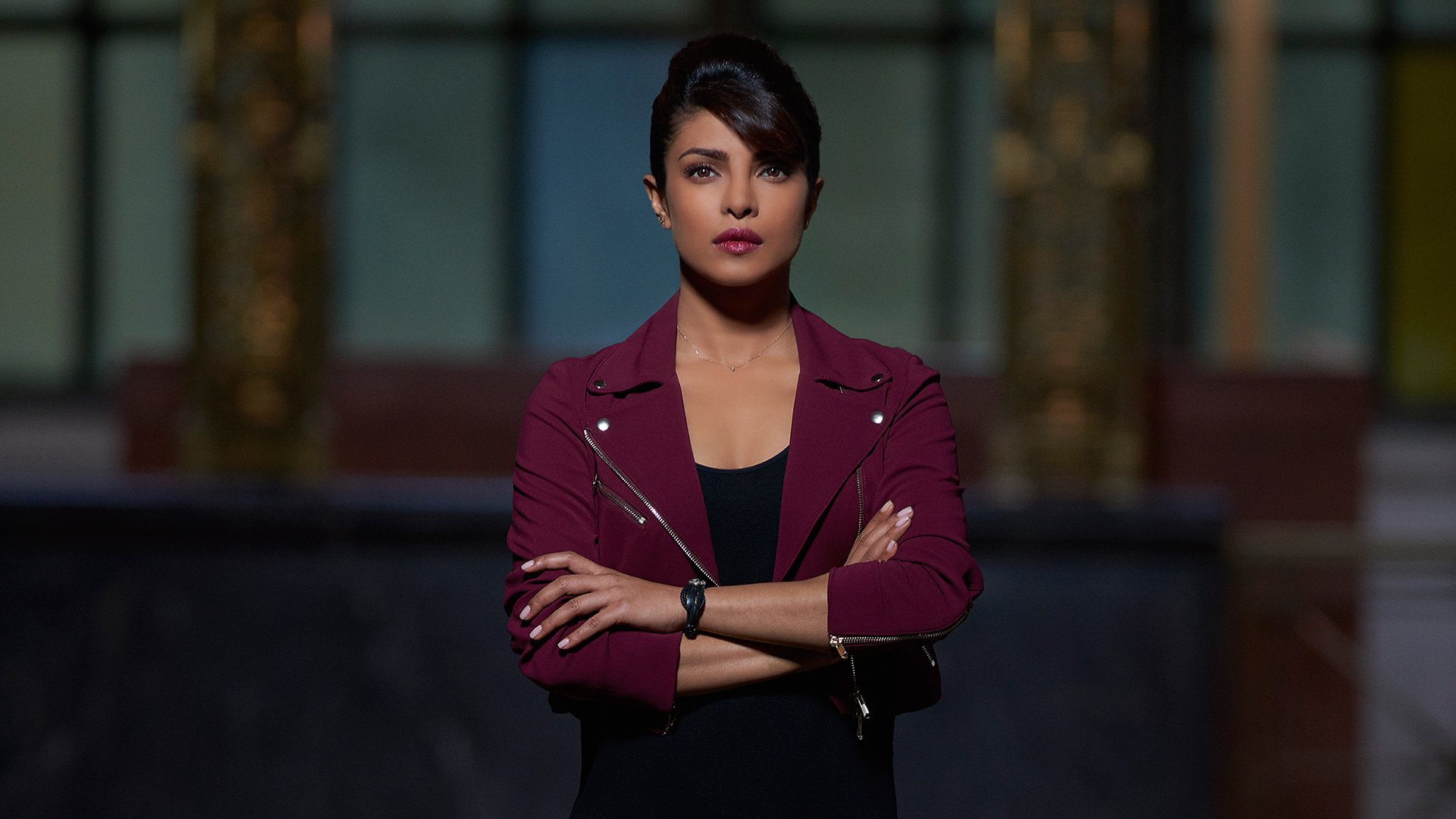 HD desktop wallpaper featuring Priyanka Chopra from the TV show Quantico, with a confident pose and dark, dramatic background.