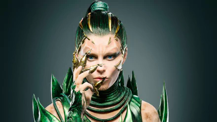 A striking image of Elizabeth Banks as Rita Repulsa from the 2017 film Power Rangers. Her fierce expression and elaborate green costume create a captivating visual backdrop.