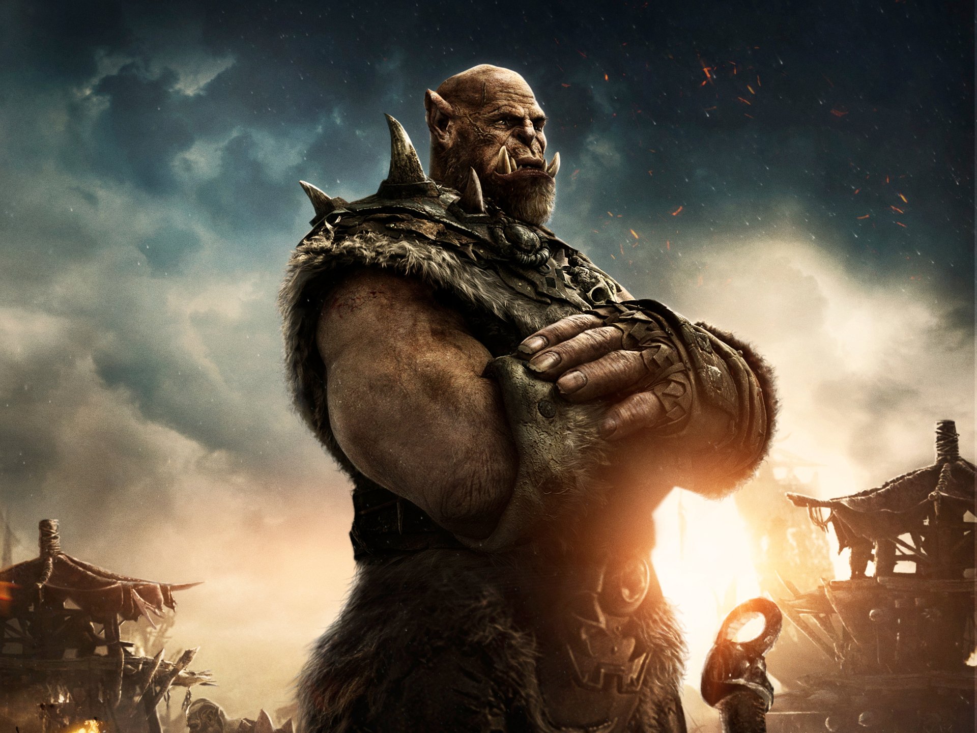 4K Ultra HD Warcraft movie wallpaper featuring a powerful orc warrior standing with crossed arms against a dramatic cloudy sky backdrop.