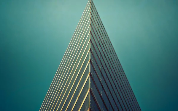 Minimalist man-made building with sharp triangular edges against a clear sky, captured in 4K Ultra HD for a striking desktop wallpaper background.