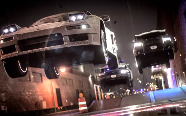 A thrilling HD wallpaper from Need For Speed (2015) features dynamic cars soaring through the air in an urban setting, capturing the essence of high-speed racing excitement.