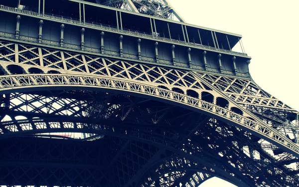 Close-up view of the intricate structure of the Eiffel Tower in Paris, showcasing its iconic iron lattice design. A vibrant 4K Ultra HD desktop wallpaper capturing man-made beauty.