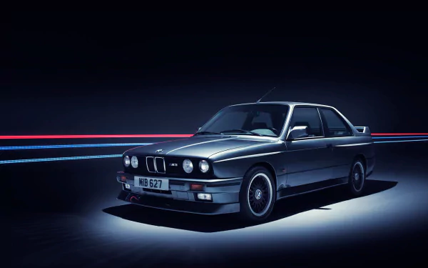 HD desktop wallpaper featuring a sleek BMW 3 Series vehicle in a dark setting with dynamic light trails, showcasing the car’s classic design and sporty appeal.
