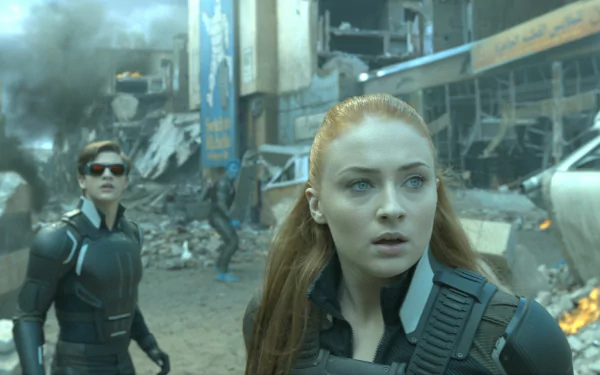 A dramatic scene from X-Men: Apocalypse featuring Cyclops, portrayed by Tye Sheridan, and Jean Grey, played by Sophie Turner, amidst chaos and destruction.