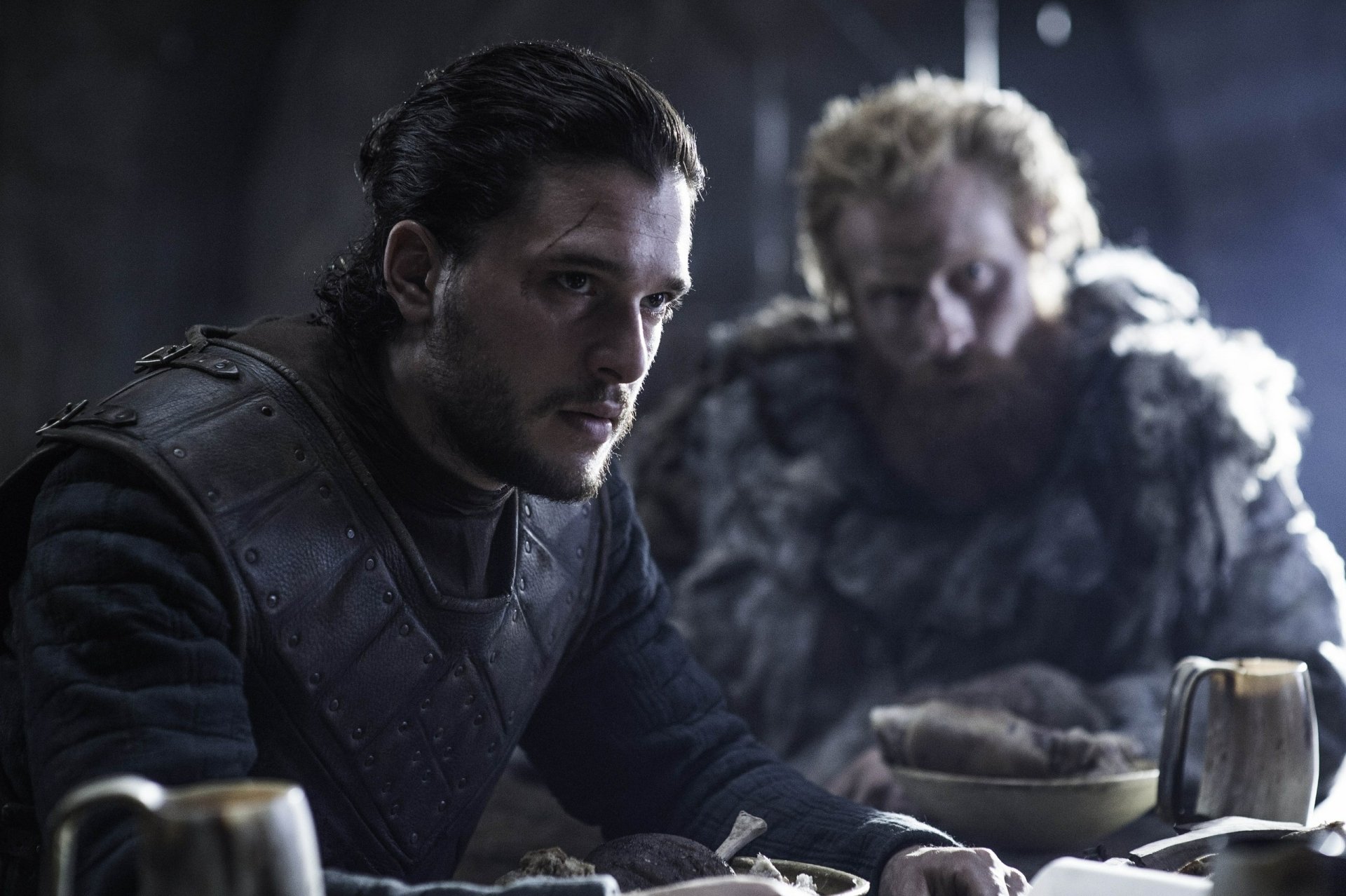 A captivating HD desktop wallpaper featuring Kit Harington as Jon Snow from the TV show Game of Thrones, showcasing a tense moment between Jon and another character in a dimly lit setting.