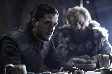 A captivating HD desktop wallpaper featuring Kit Harington as Jon Snow from the TV show Game of Thrones, showcasing a tense moment between Jon and another character in a dimly lit setting.