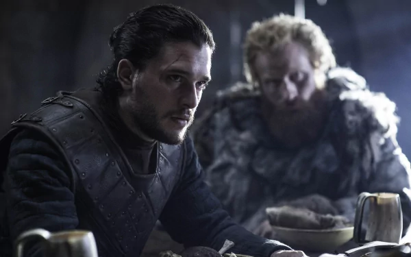A captivating HD desktop wallpaper featuring Kit Harington as Jon Snow from the TV show Game of Thrones, showcasing a tense moment between Jon and another character in a dimly lit setting.