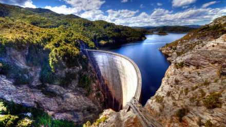 A stunning HD desktop wallpaper of the man-made Gordon Dam and lake nestled in Tasmania, Australia, showcasing natural beauty and engineering.