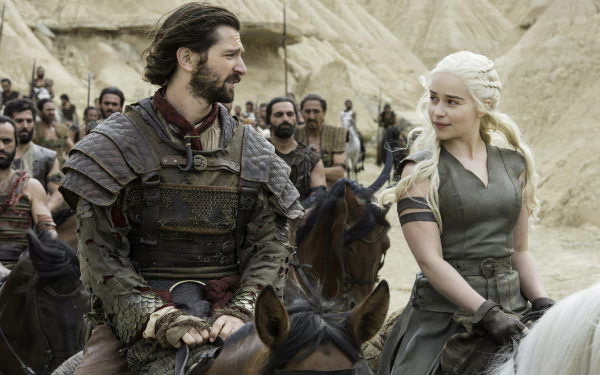 HD wallpaper featuring Michiel Huisman as Daario Naharis and Emilia Clarke as Daenerys Targaryen from the TV show Game of Thrones, set against a desert backdrop.