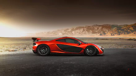 A vibrant orange McLaren P1 supercar parked on a desert road with mountains under a glowing sky, captured in high-definition as a desktop wallpaper and background.