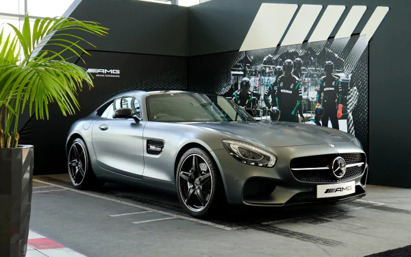 Silver Mercedes-Benz AMG sports car showcased indoors with sleek design, featured as a 4K Ultra HD PC desktop wallpaper and background.
