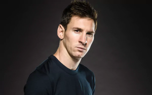 HD desktop wallpaper featuring Argentinian sports icon Lionel Messi against a dark background, portraying a confident and focused expression.
