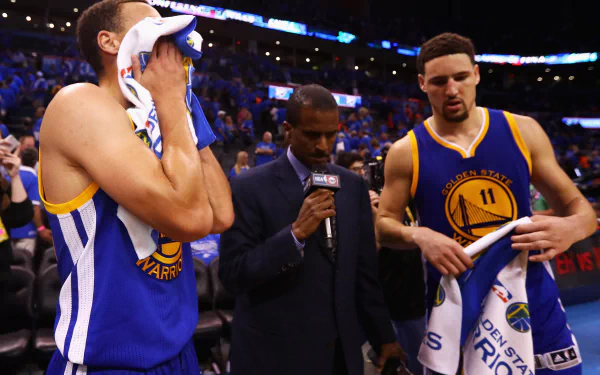 Golden State Warriors players Stephen Curry and Klay Thompson are being interviewed after a game, showcasing the intensity of sports in this HD desktop wallpaper.