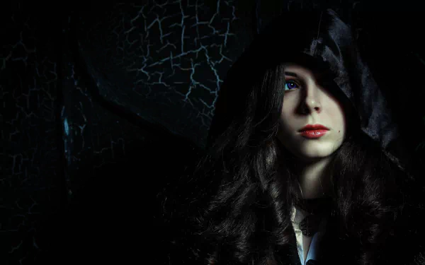 A captivating portrait of a woman in cosplay as Yennefer of Vengerberg from The Witcher 3: Wild Hunt, featuring dark, dramatic lighting and rich textures. Perfect for a HD desktop wallpaper.