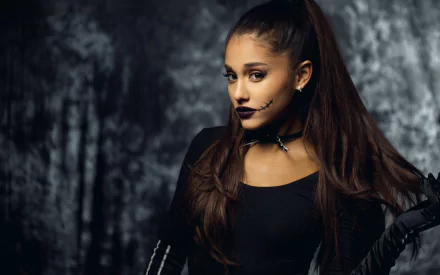 HD desktop wallpaper featuring celebrity Ariana Grande in a dark-themed costume with long brown hair and a black outfit against a textured gray background.
