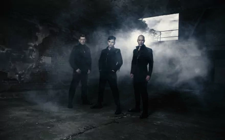 Dark, atmospheric 4K Ultra HD wallpaper featuring the rock band Oomph in a smoky, industrial setting, highlighting their edgy musician style and rock music vibe.