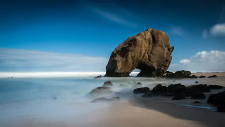 4K Ultra HD desktop wallpaper of Santa Cruz beach featuring a natural rock formation by the sea under a vibrant blue sky, showcasing coastal landscape and nature.
