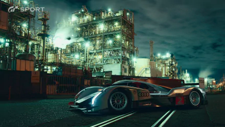 HD PC desktop wallpaper featuring a sleek race car from the video game Gran Turismo Sport, set against an illuminated industrial backdrop at night.